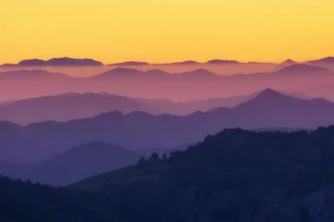Pattern of distant mountain layers at sunset Stock Photos