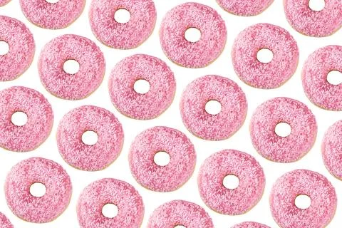Pattern of donuts decorated with pink chocolate icing and sugar sprinkles Stock Photos