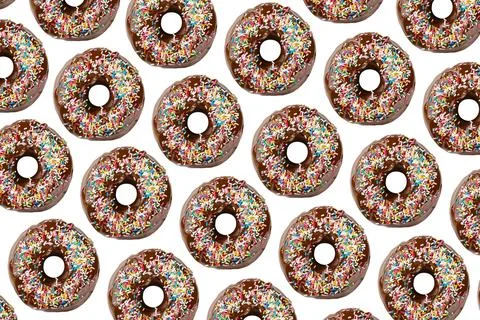 Pattern of doughnuts decorated with chocolate and colored sprinkles Stock Photos