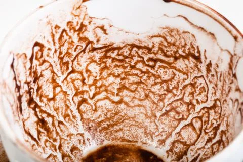 Pattern of dried carob sediments on wall of cup 스톡 사진