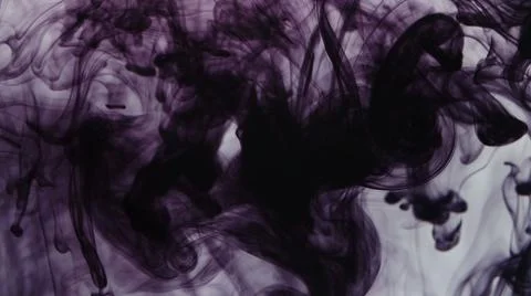 Pattern of drops of purple ink falling in liquid Stock Photos