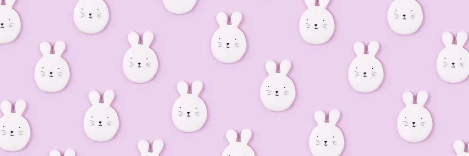Pattern of Easter bunny cookies on lilac background. Stock Photos
