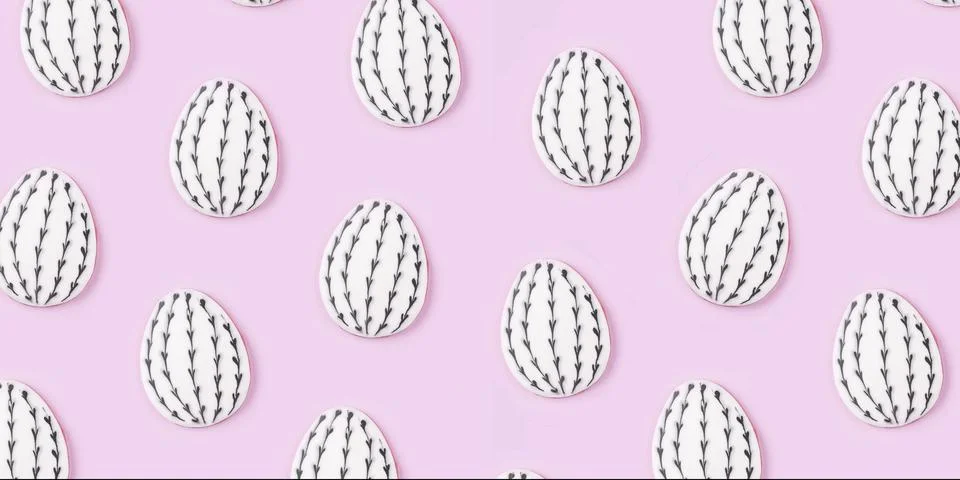 Pattern of Easter egg cookies on lilac background. Stock Photos