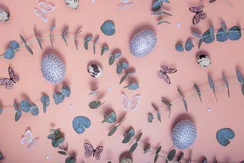 Pattern of Easter eggs, eucalyptus, butterflies and beads. Trendy flat lay .. Stock Photos