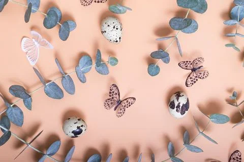 Pattern of Easter eggs, eucalyptus, butterflies and beads. Trendy flat lay .. Stock Photos