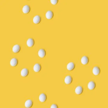 Pattern of eggs on yellow background Stock Photos