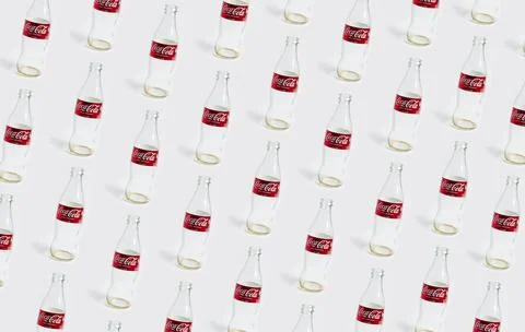 Pattern of empty coca cola bottles isolated on white background. Chisinau, .. Stock Photos