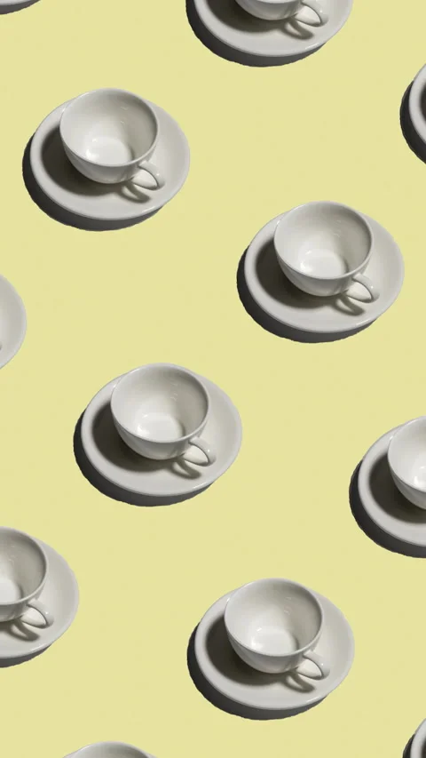 Pattern of empty tea cups with saucers casting shadows on yellow background Stock Footage 323946587