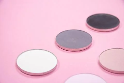 Pattern of eye shadows of different colors on a pink background 스톡 사진