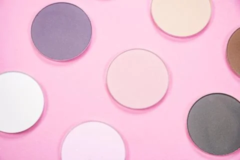 Pattern of eye shadows of different colors on a pink background 스톡 사진