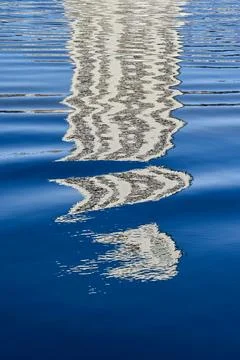 Pattern formed by the reflection of a skyscraper on rippled water. No people. Foto stock