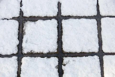 A pattern formed by snow melt on a man hole cover. Foto stock