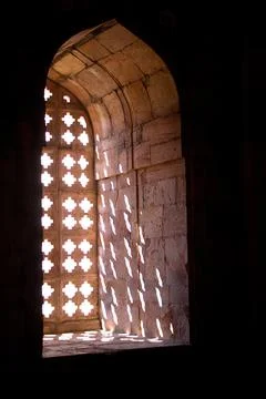 A pattern formed by sunlight passing through stone window grillwork at Jami M Stock Photos