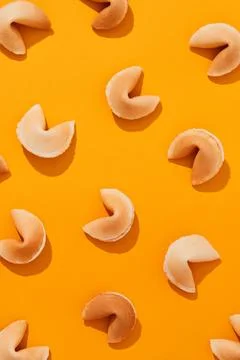 Pattern with fortune cookies on orange background with deep long shadows Stock Photos