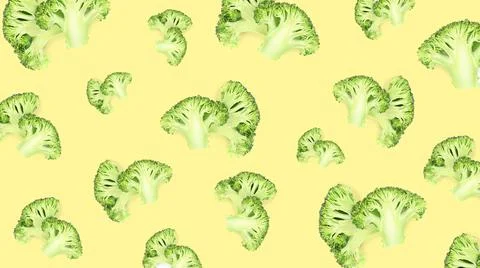 Pattern of fresh green broccoli on pale light yellow background, banner desig Stock Photos