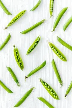 Pattern of fresh green pea pod with beans on kitchen desk. Top view Stock Photos