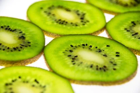 A pattern of fresh kiwi slices on a white background. Foto stock
