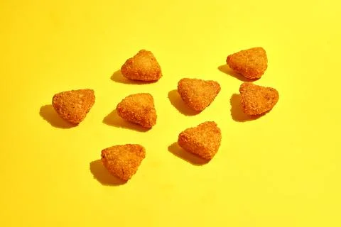 Pattern of fried mozzarella with breaded fries on a yellow background Stock Photos