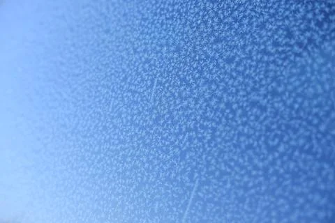 Pattern on frozen glass. unusual pattern on frozen glass. crystals of snow an Stock Photos