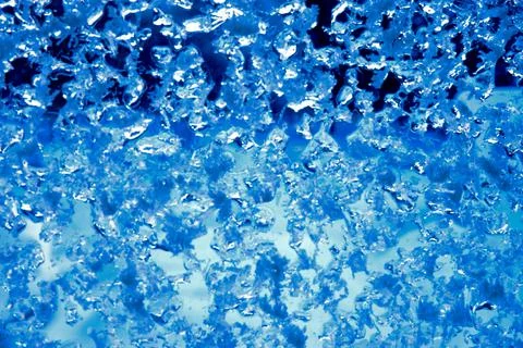 Pattern on frozen glass. unusual pattern on frozen glass. crystals of snow an Stock Photos