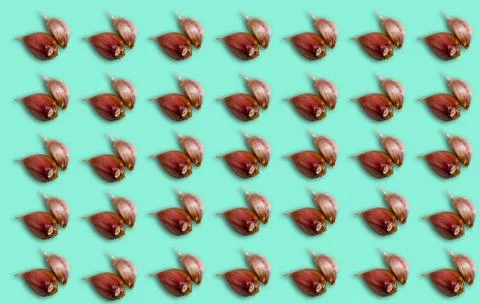 Pattern with garlic cloves on a blue background. Stock Photos