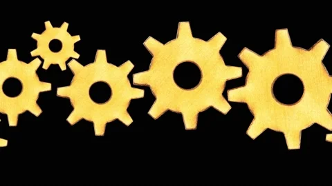 A pattern of gears of different sizes moving from left to right on a black backg Stock Footage 154500217