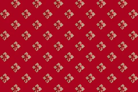 Pattern of gift boxes with a bow made with ribbon isolated on a red backgroun Stock Photos