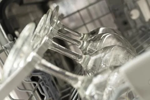 Pattern glasses of wine are stacked rhythmically in the dishwasher. Stock Photos