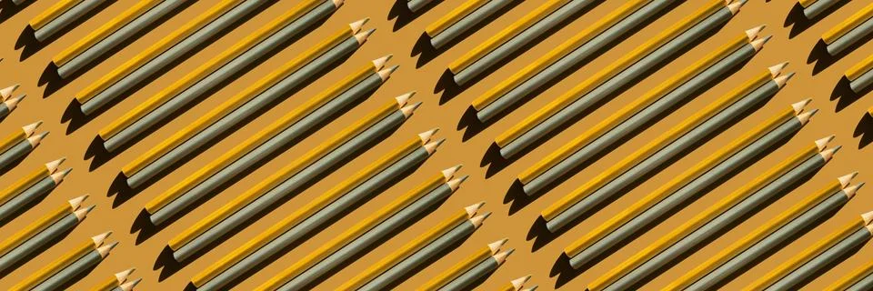 Pattern of gold and silver pencils on gold background. Banner. Stock Photos