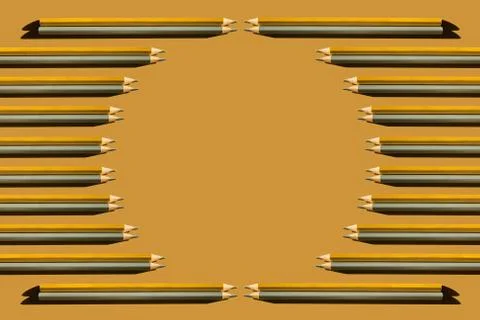 Pattern of gold and silver pencils on gold background. Stock Photos