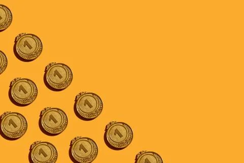 Pattern of gold medals on a yellow background. 写真素材