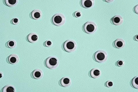 Pattern of googly eyes on blue mint background Stock Photos