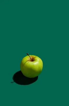Pattern of green apples on a solid green background Stock Photos