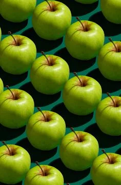 Pattern of green apples on a solid green background Stock Photos