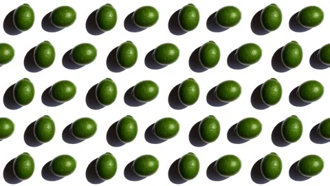 Pattern of green lemons rotating in different directions, isolated on white Stock Footage 244437971