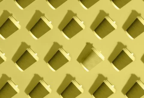 Pattern of grey paper cups on yellow background. Stock Photos