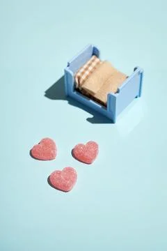 Pattern of gummy vitamin candy in shape of heart on blue background. Concept. Stock Photos