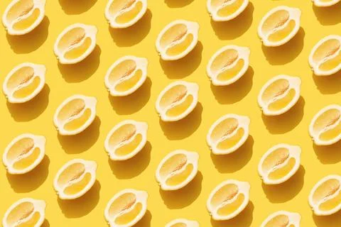  Pattern with halves of lemon with shadow on yellow background Conceptual ... Foto stock