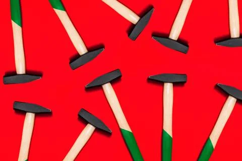 Pattern of hammers isolated on red background. Shop banner with construction Stock Photos