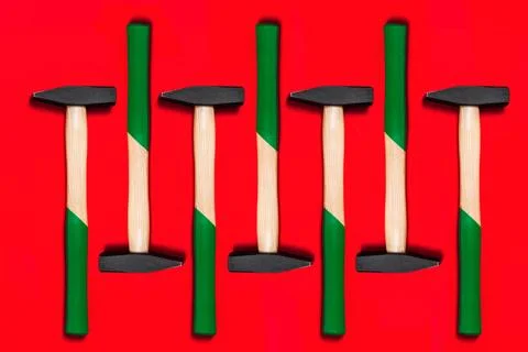 Pattern of hammers isolated on red background. Shop banner with construction Photos