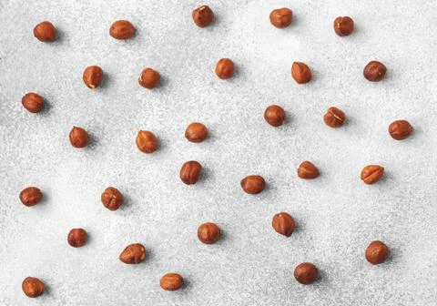 Pattern of hazelnuts on grey surface top view Stock Photos