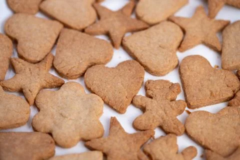Pattern of heart star and bell cookies filling frame, repeating shapes create Stock Photos