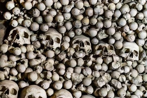 Pattern human skull with red eyes among bones creepy background demonic Stock Photos