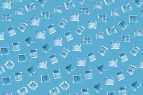 Pattern from ice cubes on a blue background. Stock Photos