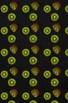 Pattern of kiwi. Top view of the sliced kiwi on black background. Minimal flat Stock Photos