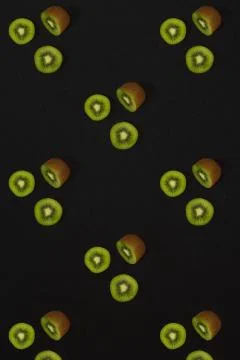 Pattern of kiwi. Top view of the sliced kiwi on black background. Minimal flat Stock Photos