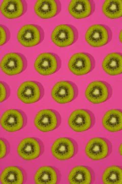 Pattern of kiwi. Top view of the sliced kiwi on pink background. Minimal flat Stock Photos