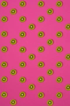 Pattern of kiwi. Top view of the sliced kiwi on pink background. Minimal flat Stock Photos