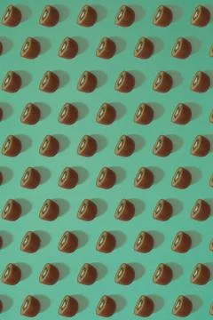Pattern of kiwi. Top view of the sliced kiwi on blue background. Minimal flat Stock Photos
