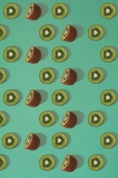 Pattern of kiwi. Top view of the sliced kiwi on blue background. Minimal flat Stock Photos